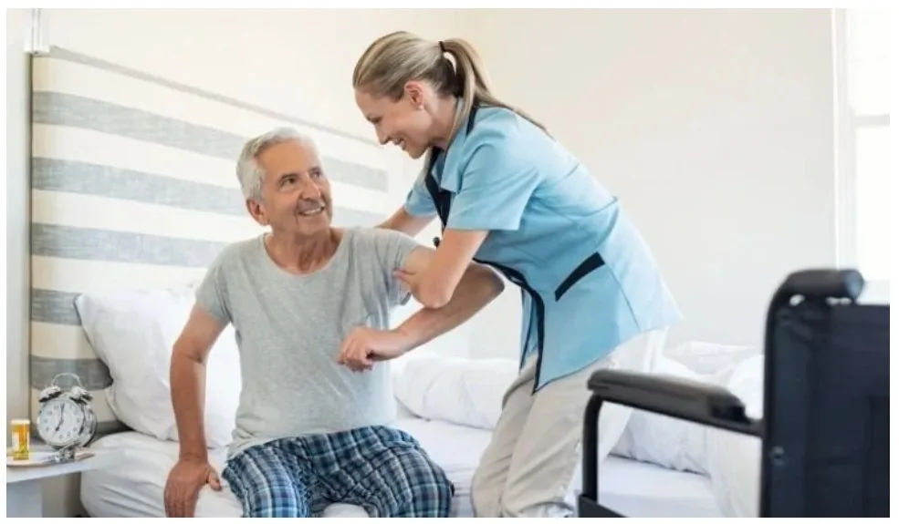 A caregiver helping a client get up safely at home