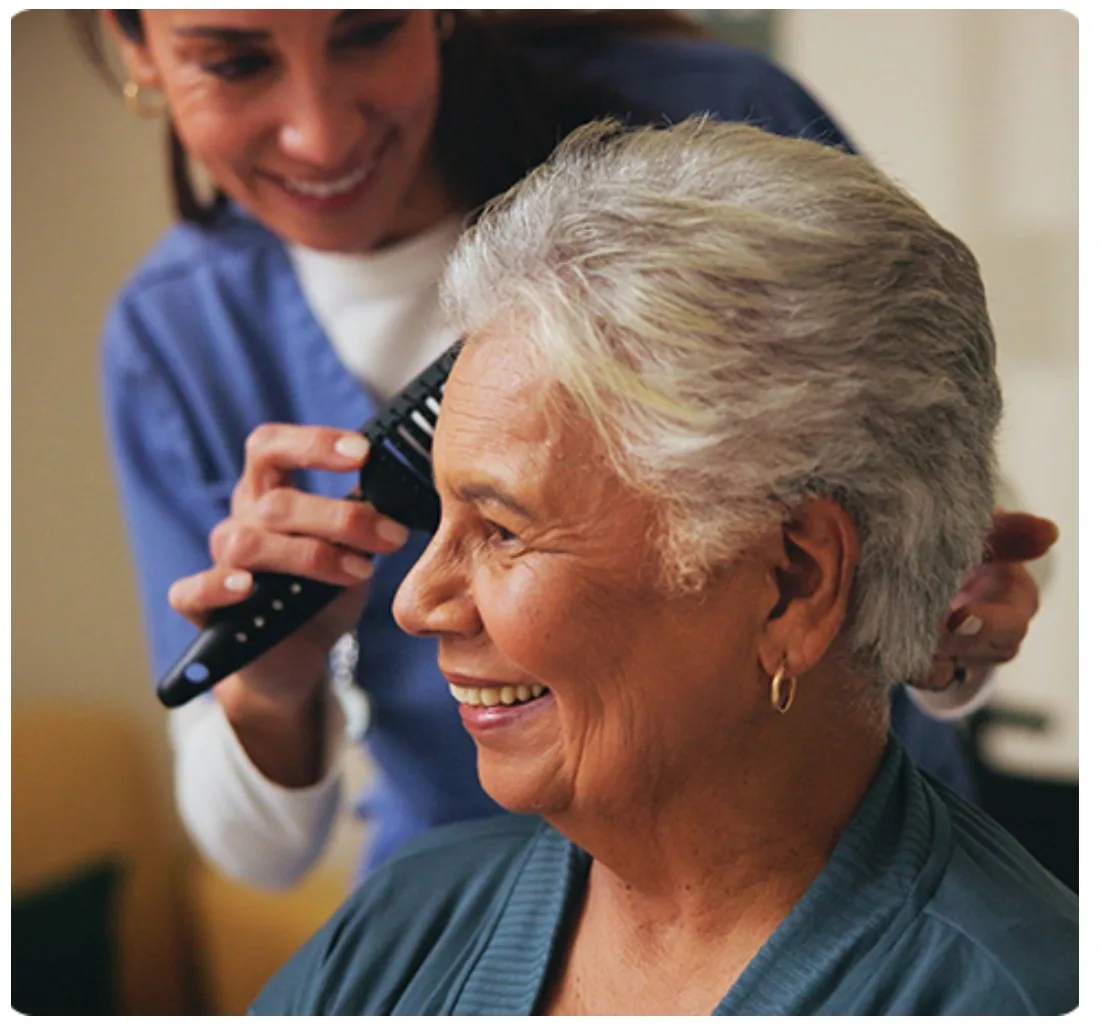 A caregiver helping a client with personal care at home